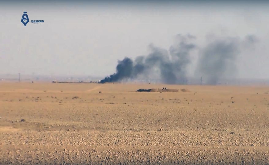 This frame grab from video provided by Qasioun a Syrian opposition media outlet, shows smoke rising as a result of clashes between U.S.-backed forces and the Islamic State group, near Ein Issa, north of Raqqa, Syria. Backed by U.S. airstrikes, Kurdish-led Syrian fighters clashed on Monday with Islamic State militants north of the city of Raqqa in Syria as they pushed ahead in their offensive aiming to liberate the city that has been the de facto capital of the extremist group since 2014. (Qasioun a Syrian Opposition Media Outlet, via AP)