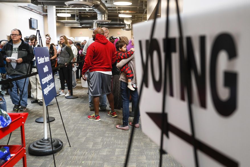 A line of early voters wait in queue at the Franklin County Board of Elections, Monday, Nov. 7, 2016, in Columbus, Ohio. Heavy turnout has caused long lines as voters take advantage of their last opportunity to vote before election day. (Associated Press) **FILE**