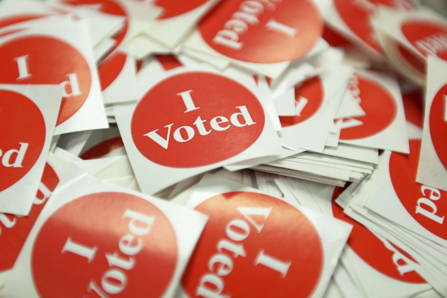In this Sept. 23, 2016, file photo, "I Voted" stickers sit for voters upon dropping off their absentee ballot at the elections office inside the Plato Building in St. Paul, Minn. (Liam James Doyle/The Minnesota Daily via AP) ** FILE **