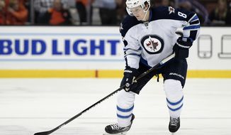 This April 5, 2016 photo shows Winnipeg Jets defenseman Jacob Trouba (8) in action during the first period of an NHL hockey game against the Anaheim Ducks in Anaheim, Calif. Trouba’s contract stalemate with the Winnipeg Jets is over as the defenseman agreed to terms Monday, Mov. 7, 2016 on a $6 million, two-year deal. (AP Photo/Kelvin Kuo)