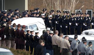 Law enforcement officers enter the Lutheran Church of Hope before funeral services for Des Moines police officer Sgt. Anthony Beminio, Monday, Nov. 7, 2016, in West Des Moines, Iowa. Beminio and Urbandale, Iowa, police officer Justin Martin were shot to death last week while sitting in their patrol cars in what authorities described as separate ambush-style attacks. (AP Photo/Charlie Neibergall)