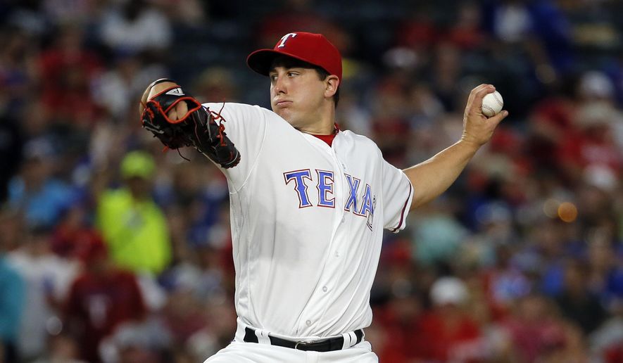 FILE - This Sept. 21, 2016 file photo shows Texas Rangers starting pitcher Derek Holland (45) throwing to the Los Angeles Angels in the second inning of a baseball game in Arlington, Texas. Holland has become a free agent after the Texas Rangers declined their $11 million option on his contract and instead chose to pay the left-hander a $1.5 million buyout. The AL West champions announced the move Monday, Nov. 7, 2016 but left open the possibility of re-signing Holland. (AP Photo/Tony Gutierrez, file)