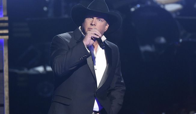 FILE - In this Nov. 2, 2016 file photo, Garth Brooks performs at the 50th annual CMA Awards in Nashville, Tenn. NBC said Monday, Nov. 7, that Brooks will be a key adviser on “The Voice” next week, mentoring the show’s top 12 contestants. (Photo by Charles Sykes/Invision/AP, File)