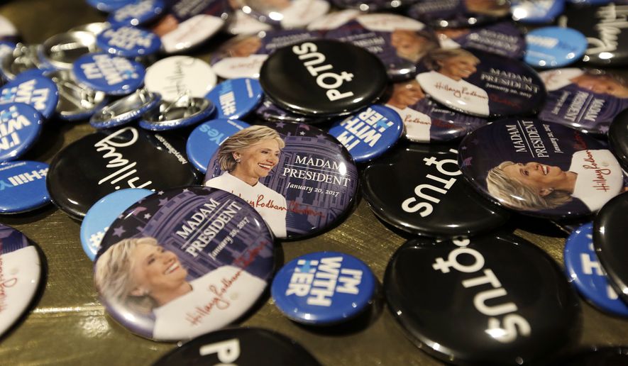 Buttons supporting presidential candidate Hillary Clinton fill a table for sale at an election night party for Democrats Tuesday, Nov. 8, 2016, in Seattle. (AP Photo/Elaine Thompson)