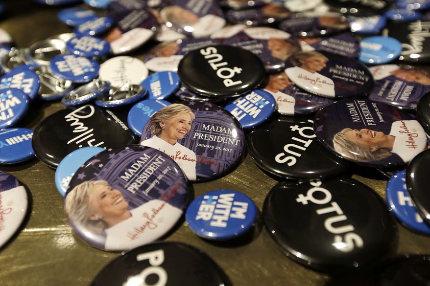 Buttons supporting presidential candidate Hillary Clinton fill a table for sale at an election night party for Democrats Tuesday, Nov. 8, 2016, in Seattle. (AP Photo/Elaine Thompson)