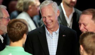 U.S. Sen. Ron Johnson, R-Wis., visits with supporters at his Election Night party at the Oshkosh Convention Center in Oshkosh, Wis., Tuesday, Nov. 8, 2016. (Michael P. King/Wisconsin State Journal via AP)
