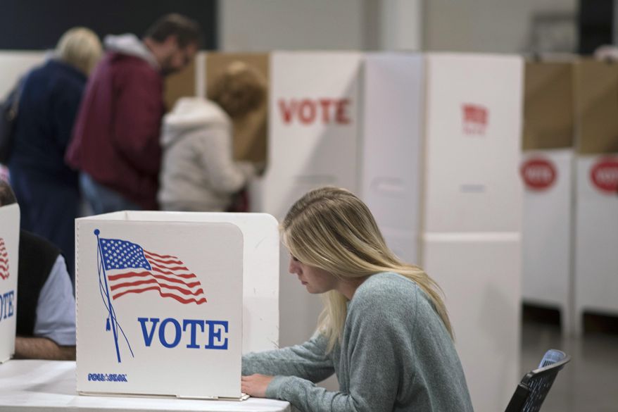 A woman votes with others at a Edmond, Okla., church Tuesday, Nov. 8, 2016. (AP Photo/J Pat Carter) ** FILE **
