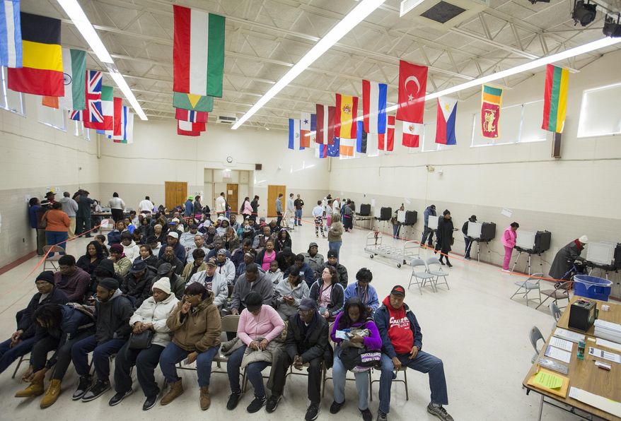Voters sit in rows of chairs at Rosemont Middle School as they wait their turn to cast their ballots on Election Day in Norfolk, Va., Tuesday, Nov. 8, 2016. (Bill Tiernan/The Virginian-Pilot via AP)