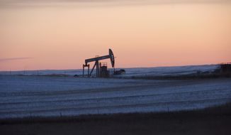 A pump jack for pulling oil from the ground is seen here near New Town, N.D., on Feb. 25, 2015. (Associated Press) **FILE**