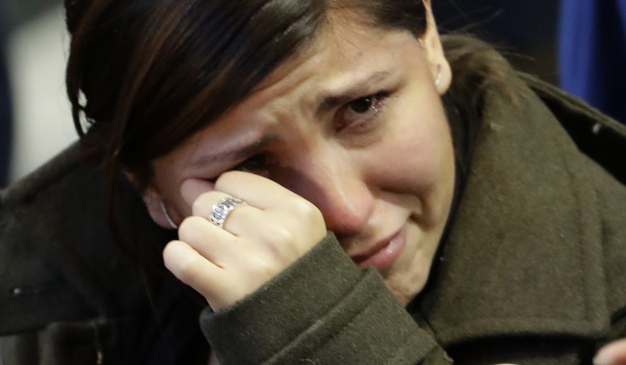 A woman cries as election results are announced during Democratic presidential nominee Hillary Clinton's election night rally in the Jacob Javits Center glass enclosed lobby in New York, Tuesday, Nov. 8, 2016. (AP Photo/David Goldman)