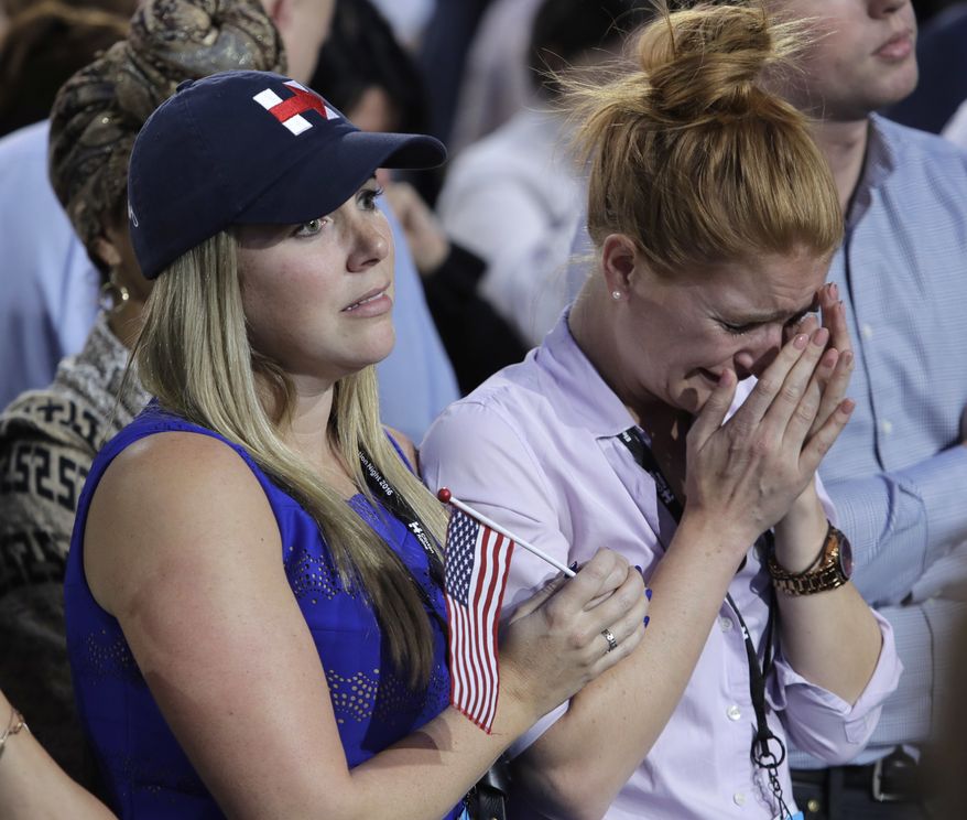 A woman weeps as election results are announced during Democratic presidential nominee Hillary Clinton's election night rally in the Jacob Javits Center glass enclosed lobby in New York, Tuesday, Nov. 8, 2016. (AP Photo/Frank Franklin II)