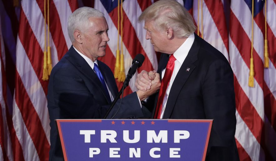 President-elect Donald Trump shakes hands with Vice President-elect Mike Pence as he gives his acceptance speech during his election night rally,  Wednesday, Nov. 9, 2016, in New York. (AP Photo/John Locher)