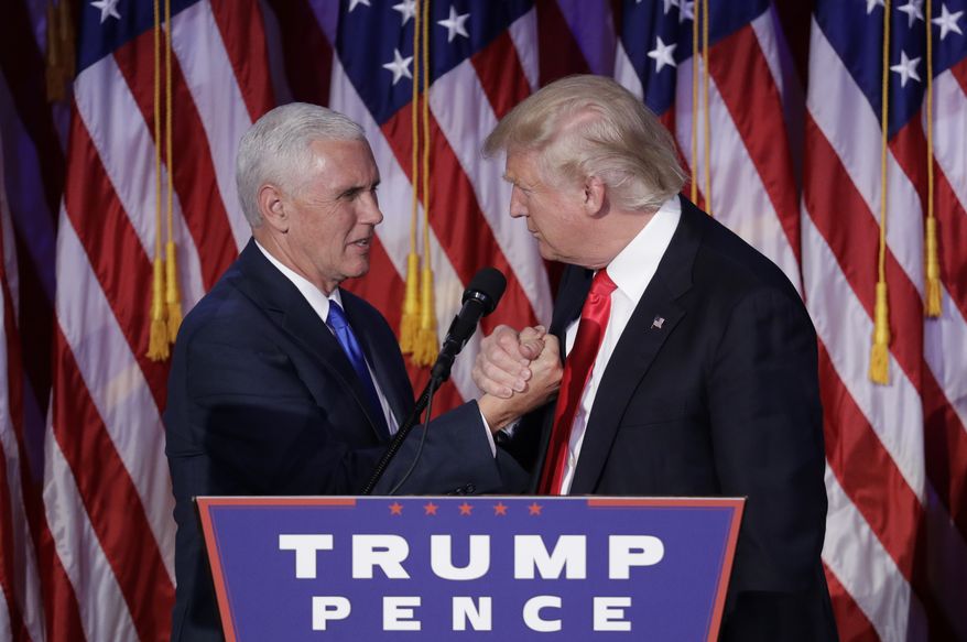 President-elect Donald Trump shakes hands with Vice President-elect Mike Pence as he gives his acceptance speech during his election night rally, Wednesday, Nov. 9, 2016, in New York. (AP Photo/John Locher)