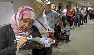 Hana Alshamry, left, waits in line with others to vote at the Holladay City Hall Tuesday, Nov. 8, 2016, in Holladay, Utah. Utah&#39;s mostly Mormon, mostly Republican voters are going to the polls Tuesday to determine if the GOP&#39;s five-decade winning streak in presidential elections will remain intact or be snapped. (AP Photo/Rick Bowmer)