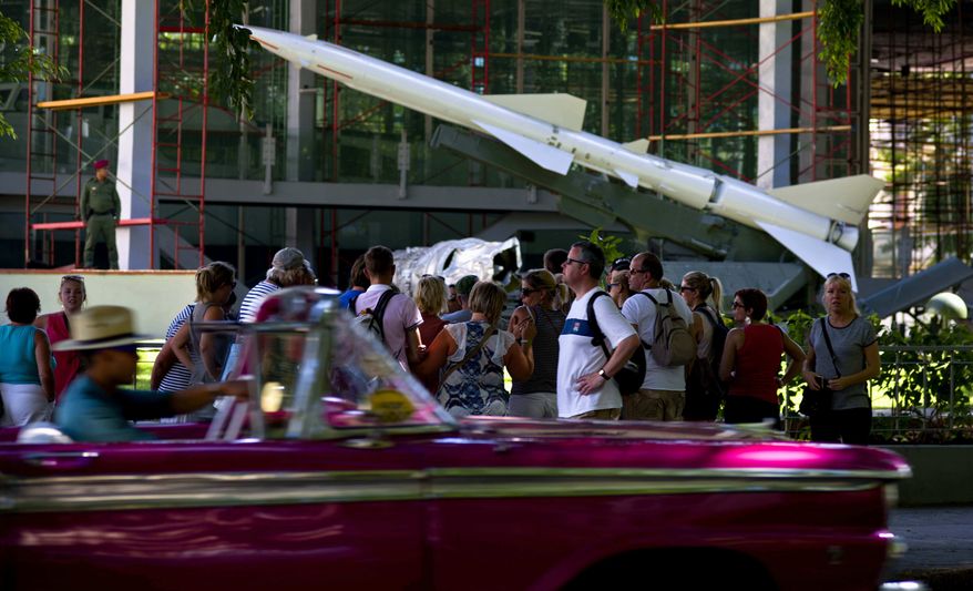 Tourists listen to a tour guide near an anti-aircraft missile on exhibit at the Revolution Museum, in Havana, Cuba, Wednesday, Nov. 9, 2016. Cubans fear President-elect Donald Trump will reverse 2-year-old detente. The Cuban government, meanwhile, announced the launch of five days of nationwide military exercises to prepare troops to confront what the government called ‘a range of enemy actions.’ (AP Photo/Ramon Espinosa)