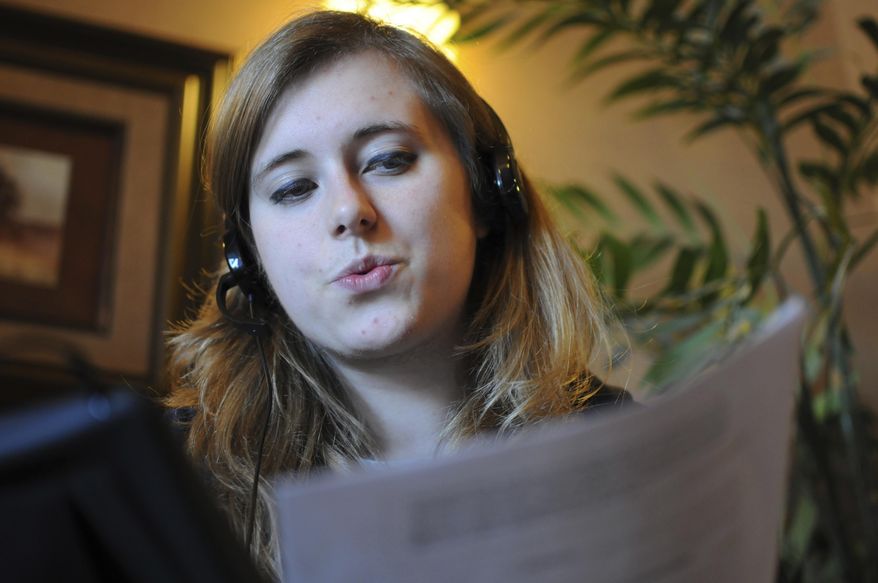 FILE - In this Oct. 22, 2016 file photo, Christine Keller, a college student, makes calls against South Dakota's Initiated Measure 22 in Sioux Falls, S.D. Voters on Tuesday, Nov. 8 approved the measure, which will allow people to tap a state fund to send two $50 credits to participating political candidates. (AP Photo/James Nord)