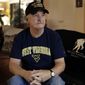 ADVANCE FOR USE FRIDAY, NOV. 11, 2016 AND THEREAFTER-Mike Baughman sits for a photo at his home in Danville, Calif., on Tuesday, Aug. 2, 2016. The 64-year-old is among hundreds of veterans who have been diagnosed with a rare form of bile duct cancer that may be linked to their time in the service and an unexpected source: parasites in raw or poorly cooked river fish. (AP Photo/Ben Margot)