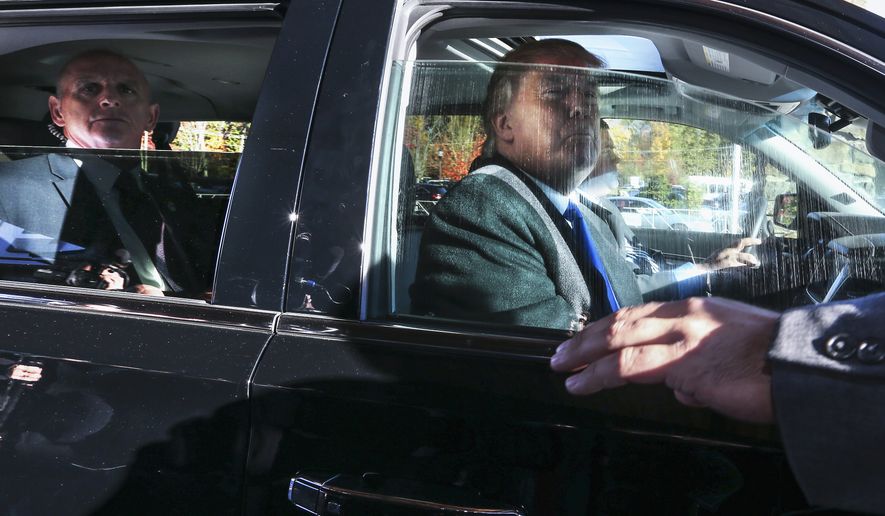 Donald Trump looks out from his car window in this Associated Press file photo.