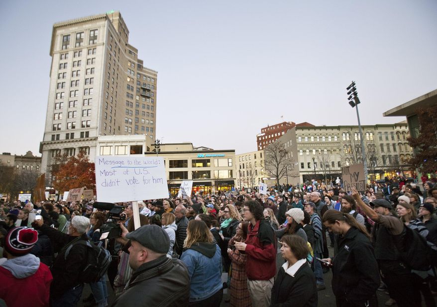 Protesters gather at Rosa Parks Circle in Grand Rapids, Mich., Thursday, Nov. 10, 2016, in opposition of Donald Trump's presidential election victory. (Cory Morse/The Grand Rapids Press via AP)
