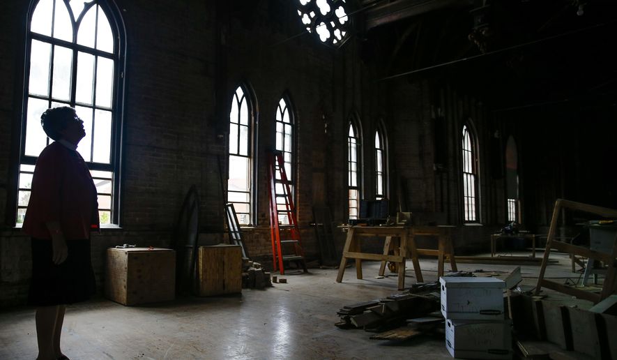 ADVANCE FOR SUNDAY NOV. 13 AND THEREAFTER - In a Oct. 11, 2016 photo, Trinity Episcopal Church Rev.Susan Kennard looks up at the restoration work being done to the 1870s-era Eaton Chapel to save the space, which was designed by famed architect Nicholas Clayton, in Galveston. ( Michael Ciaglo/Houston Chronicle via AP)