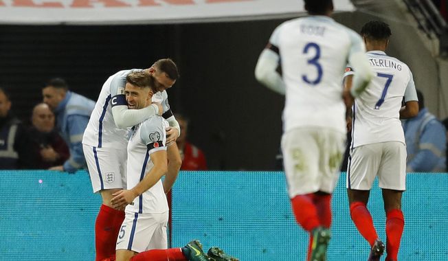 England&#x27;s Gary Cahill, second left is congratulated by teammate England&#x27;s Wayne Rooney, right, after he scored his sides third goal of the game during the World Cup 2018 Group F qualification soccer match between England and Scotland at Wembley stadium in London, Friday, Nov. 11, 2016. (AP Photo/Frank Augstein)