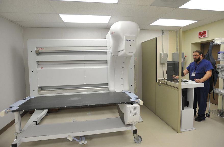 ADVANCE FOR SATURDAY, NOV. 12, AND THEREAFTER – In this Friday, Nov. 4, 2016 photo, forensic pathology assistant Rick Campitell operates a low-dosage digital X-ray machine at ForensicDx in Windber, Pa. In Cambria County, Pa., autopsies and toxicology reports are squeezing the coroner's office budget this year due to a continuing increase in drug-related fatalities, while across the region, those who perform autopsies in government agencies and private businesses report a spike in deaths they investigate tied to drug abuse. (Todd Berkey/The Tribune-Democrat via AP)