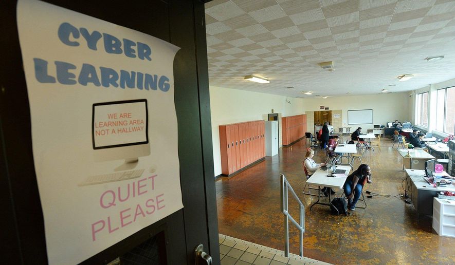 ADVANCE FOR USE SATURDAY, NOV. 12 - In this Nov. 2, 2016 photo, cyber students attend class  at Central Career and Technical School in Erie, Pa. (Jack Hanrahan/Erie Times-News via AP)