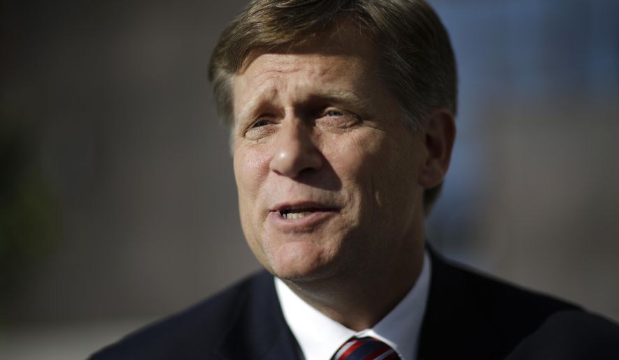 FILE - In this Feb. 7, 2014 file photo, Michael McFaul speaks with a reporter in Sochi, Russia. McFaul, the former U.S. ambassador to Russia said Friday, Nov. 11, 2016, that he has been banned from traveling there in a tit-for-tat response to U.S. visa bans for senior Russian officials. (AP Photo/David Goldman, File)