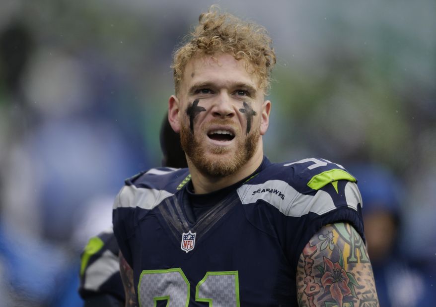 FILE - In this Dec. 27, 2015, file photo, the Seattle Seahawks' Cassius Marsh stands on the field against the St. Louis Rams in the first half of an NFL football game in Seattle. Marsh pleaded on Twitter on Nov. 9, 2016, for the person who stole his valuable collection of "Magic: The Gathering" cards to return them. (AP Photo/John Froschauer, File)