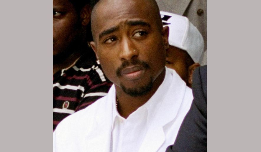 FILE - In this Aug. 15, 1996, file photo, rapper Tupac Shakur attends a voter registration event in South Central Los Angeles. The director behind FX’s acclaimed “People vs. O.J. Simpson” miniseries is set to tackle another true crime drama, this one based on the unsolved deaths of Shakur and fellow rapper Biggie Smalls. The Hollywood Reporter reported Nov. 10, 2016, that USA Network has ordered a pilot for “Unsolved,” which will be directed by Anthony Hemingway. (AP Photo/Frank Wiese, File)