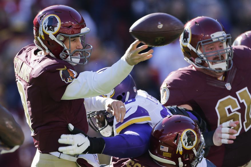 Washington Redskins quarterback Kirk Cousins (8) passes the ball under pressure during the first half of an NFL football game against the Washington Redskins in Landover, Md., Sunday, Nov. 13, 2016. (AP Photo/Mark Tenally)