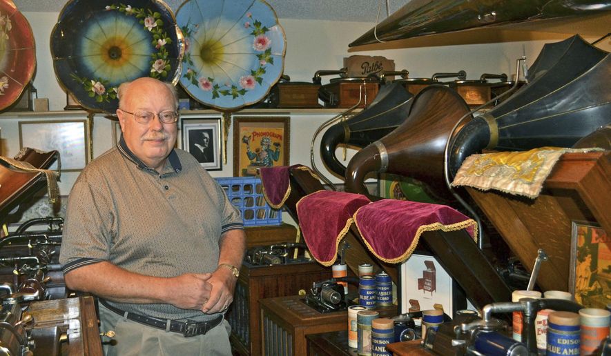ADVANCE FOR USE SUNDAY, NOV. 13 AND THEREAFTER - In this Oct. 5, 2016 photo, Burdette Walters, of Wellsburg, Iowa, a life-long collector of phonographs, poses at home with part of his collection. He owns over 175 phonographs of varying age, size and brand. (Sara Jordan-Heintz/The Times-Republican via AP)