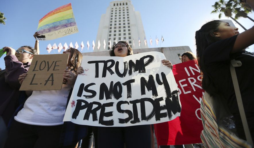Students from several high schools rally after walking out of classes to protest the election of Donald Trump at City Hall in downtown Los Angeles Monday, Nov. 14, 2016. (AP Photo/Reed Saxon)