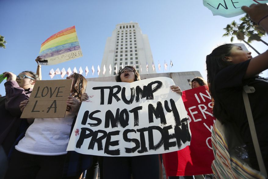 Students from several high schools rally after walking out of classes to protest the election of Donald Trump at City Hall in downtown Los Angeles Monday, Nov. 14, 2016. (AP Photo/Reed Saxon)