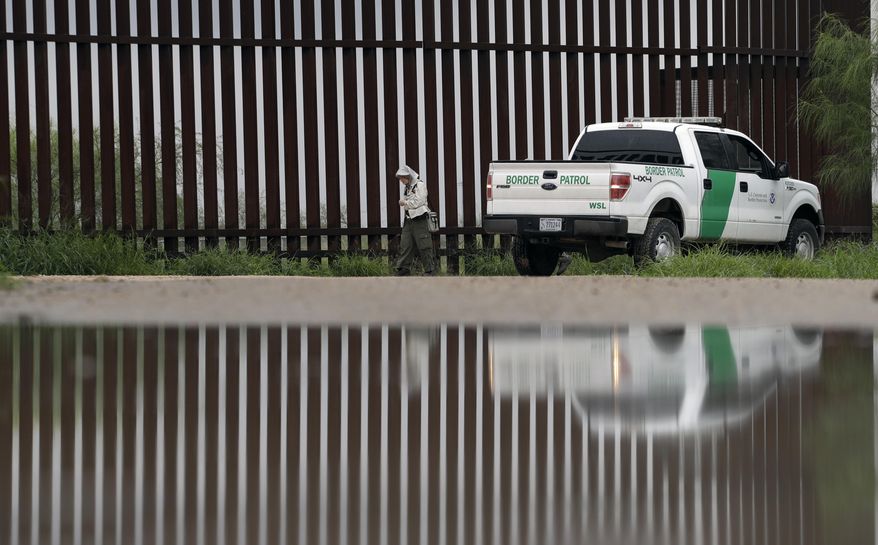 A U.S. Customs and Border Patrol agent passes birdwatcher Nancy Hill, 81, along a section of the border wall Sunday, Nov. 13, 2016, in Hidago, Texas. President-elect Donald Trump is starting to sound a lot more like President Barack Obama on his stance on immigration and easing his pledge to build a wall across the Mexican border. (AP Photo/Eric Gay)