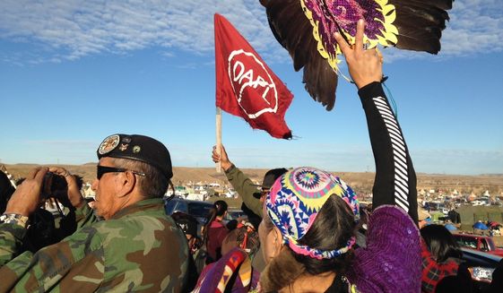 Demonstrators against the Dakota Access oil pipeline hold a ceremony at the main protest camp Tuesday, Nov. 15, 2016, near Cannon Ball, North Dakota. The ceremony was in honor of Robert F. Kennedy Jr., an environmental attorney and president of the New York-based Waterkeeper Alliance, who visited the Dakota Access oil pipeline protesters Tuesday. (AP Photo/James MacPherson)