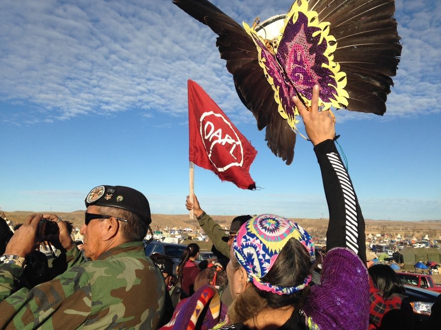 Demonstrators against the Dakota Access oil pipeline hold a ceremony at the main protest camp Tuesday, Nov. 15, 2016, near Cannon Ball, North Dakota. The ceremony was in honor of Robert F. Kennedy Jr., an environmental attorney and president of the New York-based Waterkeeper Alliance, who visited the Dakota Access oil pipeline protesters Tuesday. (AP Photo/James MacPherson)