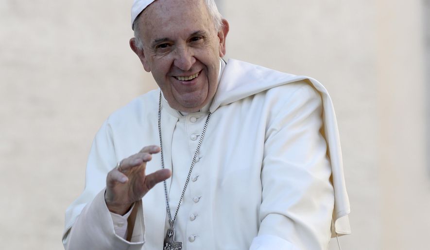 In this Oct. 19, 2016, photo, Pope Francis waves to the crowd as he is driven around St. Peter's Square ahead of his weekly general audience, at the Vatican. Francis was presented by Chicago Archbishop Blase Cupich with a Chicago Cubs hat and what looks like a signed baseball at the Vatican Tuesday, Nov. 15, 2016, nearly two weeks after the Cubs won their first World Series since 1908. (AP Photo/Alessandra Tarantino, File)