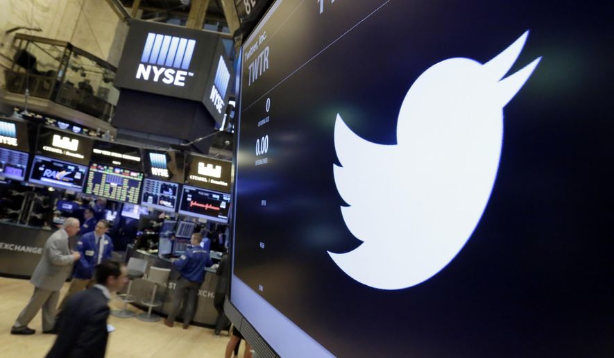 The Twitter symbol appears above a trading post on the floor of the New York Stock Exchange. (Associated Press)