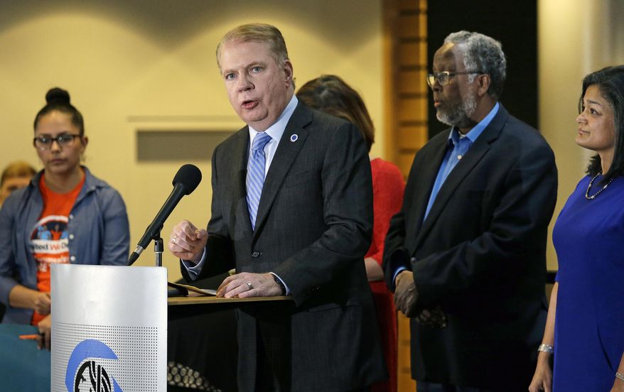 FILE - In this Nov. 9, 2016, file photo, Seattle Mayor Ed Murray, second left, speaks at a post-election event of elected officials and community leaders at City Hall in Seattle. Leaders in Seattle, San Francisco and other so-called "sanctuary cities" say they won't change their stance on immigration despite President-elect Donald Trump's vows to withhold potentially millions of dollars in taxpayer money if they don't cooperate. (AP Photo/Elaine Thompson, File)