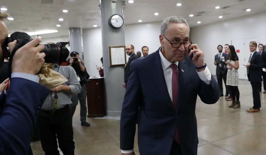 Sen. Chuck Schumer, D-N.Y. talks on the phone as the walks on Capitol Hill in Washington, Wednesday, Nov. 16, 2016. Senate Democrats have elected Schumer to be the new minority leader when Congress convenes in January. (AP Photo/Alex Brandon)