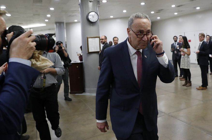 Sen. Chuck Schumer, D-N.Y. talks on the phone as the walks on Capitol Hill in Washington, Wednesday, Nov. 16, 2016. Senate Democrats have elected Schumer to be the new minority leader when Congress convenes in January. (AP Photo/Alex Brandon)