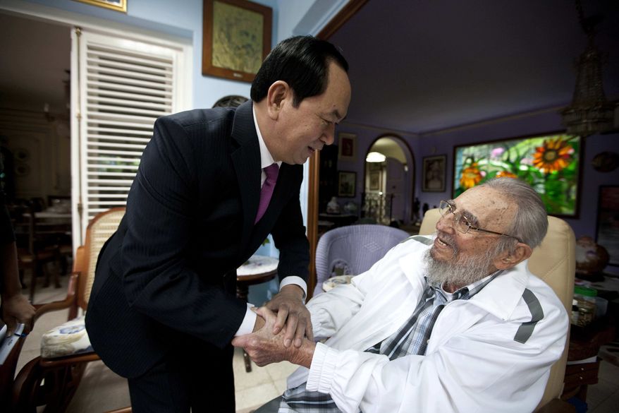 Cuba's former leader Fidel Castro, right, shakes hands with Vietnamese President Tran Dai Quang, left, in Havana, Cuba, Tuesday, Nov. 15, 2016. Quang is on a two-day official visit to Cuba. (AP Photo/Alex Castro)