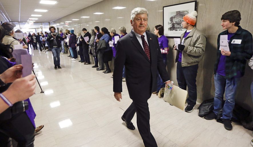 FILE - In this Jan. 12, 2016, file photo, state Sen. Randy McNally, R-Oak Ridge, walks past protesters lining the tunnel connecting the legislative office complex to the state Capitol on the opening day of the second session of the 109th General Assembly in Nashville, Tenn. Senate Republicans, who control 28 of 33 seats in the upper chamber of the General Assembly, are scheduled to meet Thursday, Nov. 17, 2016, to nominate their leaders. McNally has been the consensus choice to succeed Speaker Ron Ramsey, who has retired. (AP Photo/Mark Humphrey, File)