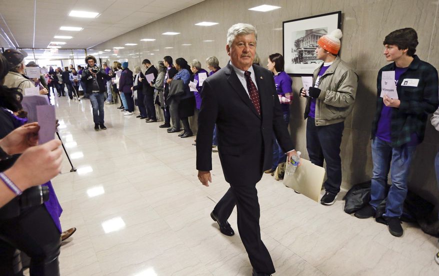 FILE - In this Jan. 12, 2016, file photo, state Sen. Randy McNally, R-Oak Ridge, walks past protesters lining the tunnel connecting the legislative office complex to the state Capitol on the opening day of the second session of the 109th General Assembly in Nashville, Tenn. Senate Republicans, who control 28 of 33 seats in the upper chamber of the General Assembly, are scheduled to meet Thursday, Nov. 17, 2016, to nominate their leaders. McNally has been the consensus choice to succeed Speaker Ron Ramsey, who has retired. (AP Photo/Mark Humphrey, File)