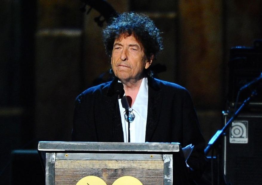 FILE - In this Feb. 6, 2015 file photo, Bob Dylan accepts the 2015 MusiCares Person of the Year award at the 2015 MusiCares Person of the Year show in Los Angeles. The Swedish Academy says Dylan is not coming to Stockholm to pick up his 2016 Nobel Prize for literature at the Dec. 10, 2016 prize ceremony. (Photo by Vince Bucci/Invision/AP, File)