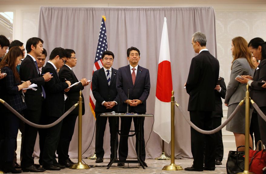 Japanese Prime Minister Shinzo Abe (center) made a stop in New York to meet with President-elect Donald Trump while en route to an APEC meeting in Lima. He later describe the encounter as "cordial and candid." (Associated Press)