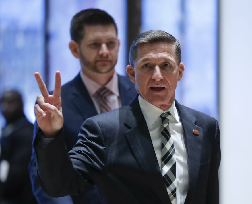 Retired Lt. Gen Michael Flynn gestures Thursday as he arrives at Trump Tower in New York. (Associated Press)