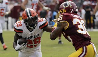 In this file photo taken Oct. 2, 2016, Washington Redskins defensive back Su&#39;a Cravens (36) attempts to tackle Cleveland Browns running back Duke Johnson (29) during the first half of an NFL football game in Landover, Md. (AP Photo/Mark Tenally) ** FILE **