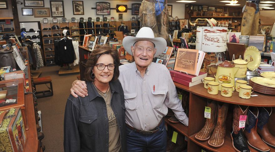 This Nov. 14, 2016 photo shows Kippie Wilkinson, left, and owner Weldon Burgoon inside of Weldon's Saddle Shop & Western Wear, which has been on Hickory Street in Denton, Texas since 1957. Weldon's will close its doors Jan. 14, 2017. An online auction will sell the remaining inventory, and in March there will be a live auction to sell Burgoon's Western collectibles. Wilkinson, Weldon's daughter, has worked in the Western store most of her life. (Barron Ludlum/The Denton Record-Chronicle via AP)